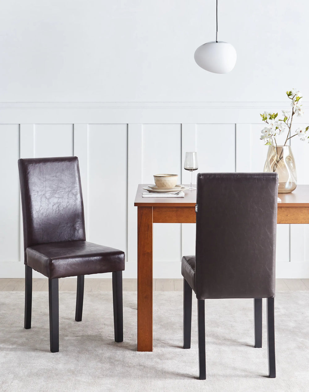 Stylish dining chair set around a wooden table, adding warmth and timeless elegance to modern dining spaces.