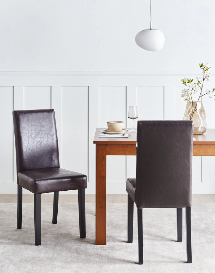 Stylish dining chair set around a wooden table, adding warmth and timeless elegance to modern dining spaces.