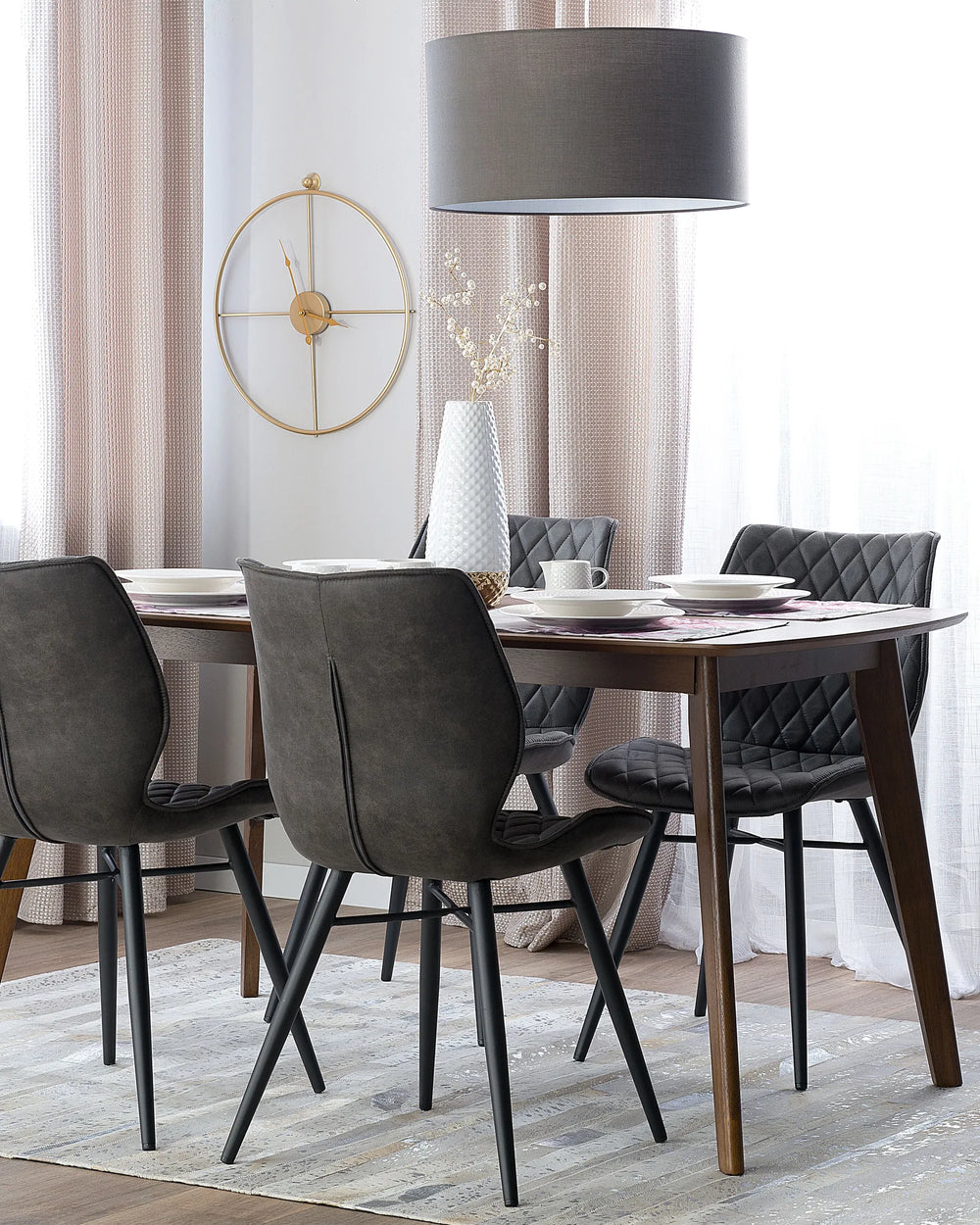 Dark grey dining chairs paired with a wooden dining table, creating a sleek and contemporary dining space.