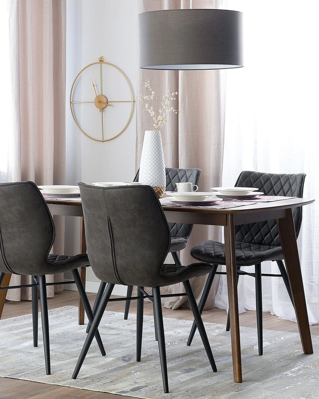 Dark grey dining chairs paired with a wooden dining table, creating a sleek and contemporary dining space.