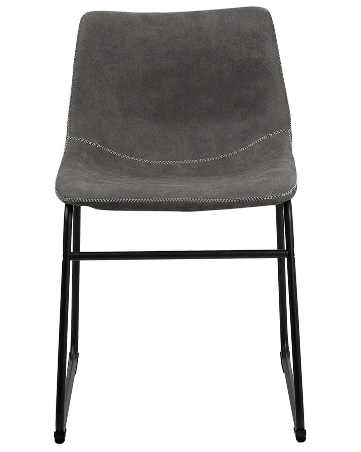 Industrial dining chair upholstered in grey faux leather with decorative stitching and a sturdy black sled base, combining comfort with modern style.