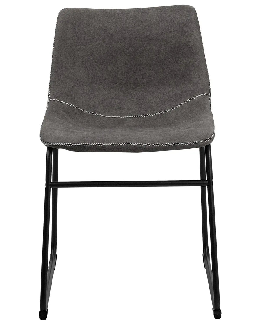Industrial dining chair upholstered in grey faux leather with decorative stitching and a sturdy black sled base, combining comfort with modern style.