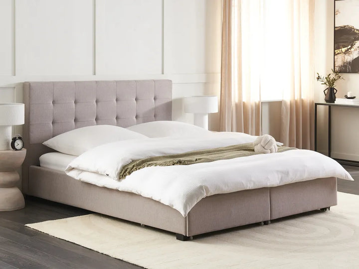 Modern bedroom with a gray upholstered bed and white bedding.