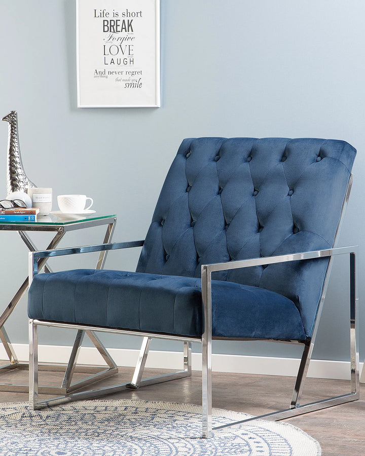 Blue armchair with chrome frame in a room with a motivational poster on the wall.