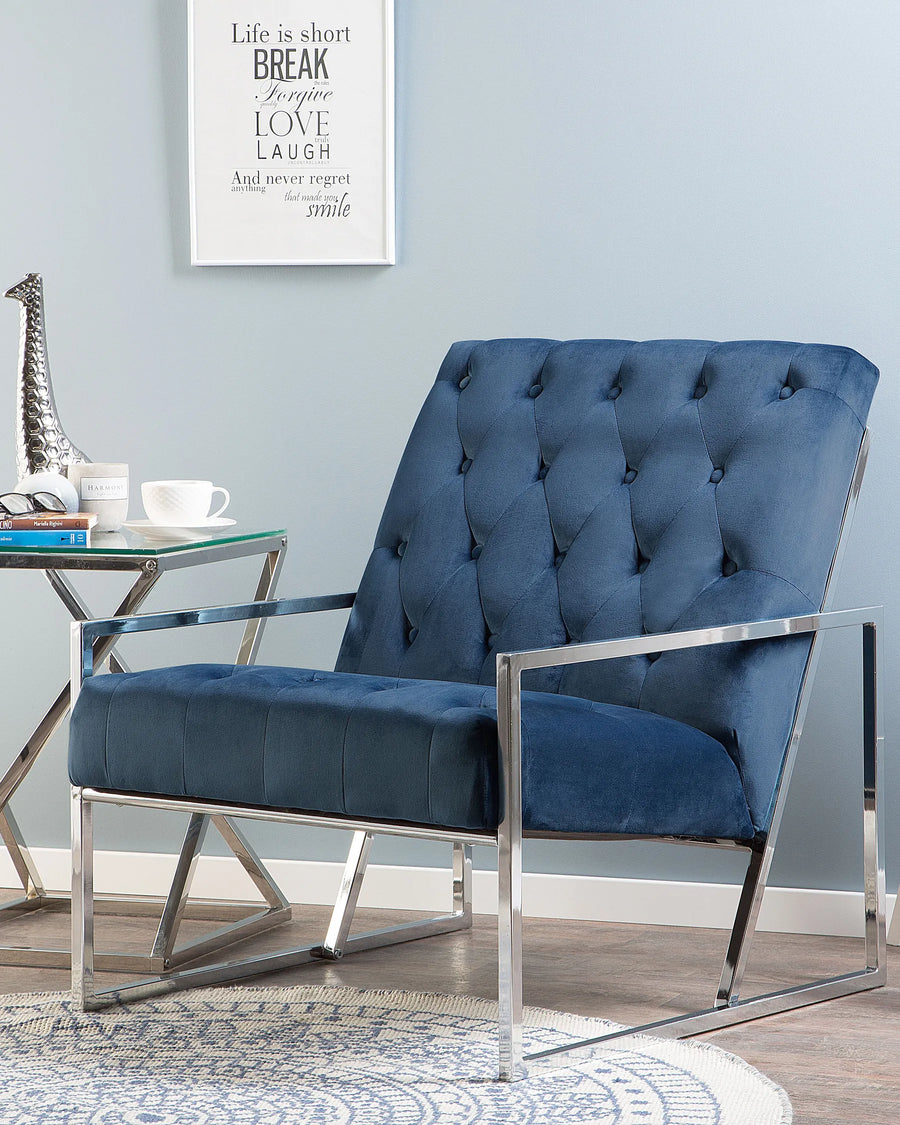 Blue armchair with chrome frame in a room with a motivational poster on the wall.