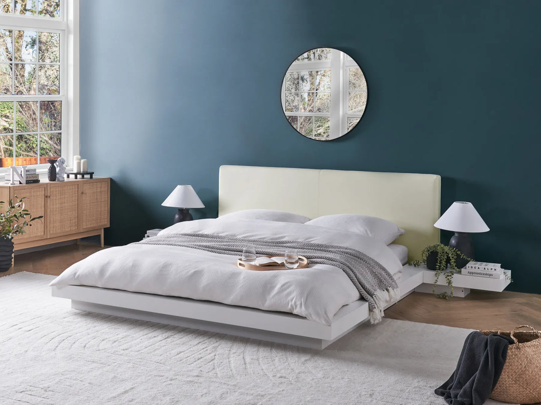Modern bedroom with a bed, nightstands, and decorative items.