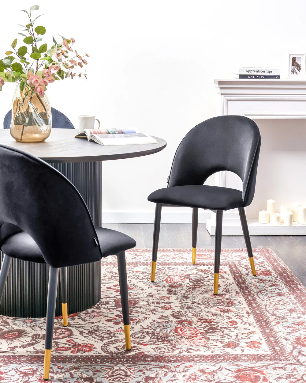 Sophisticated black velvet dining chairs styled around a contemporary dining table, adding a luxurious and modern touch to the dining space.