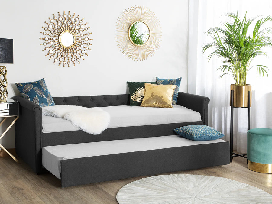 Black sofa bed with white mattress in a stylish living room.