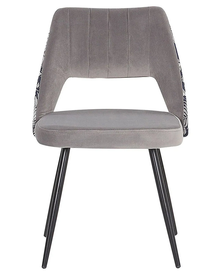 Grey upholstered dining chair with an open back, floral-patterned sides, and black metal legs.
