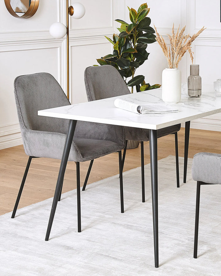 Modern dining setup featuring grey corduroy chairs that add subtle texture and a refined, minimalist look to the space.