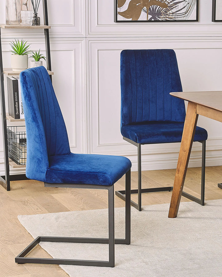 Modern dining setup featuring luxurious blue velvet chairs that add a bold, elegant touch to the room.