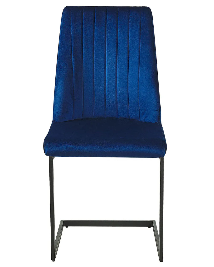 Blue velvet dining chair with vertical stitching and a sleek black cantilever frame.
