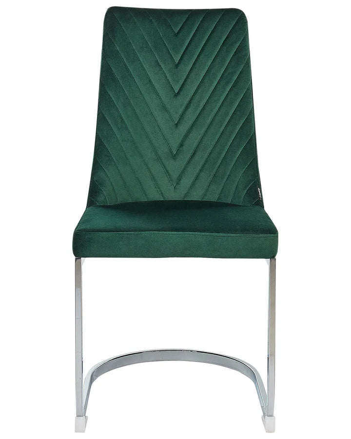 Green velvet cantilever dining chair with chrome frame.
