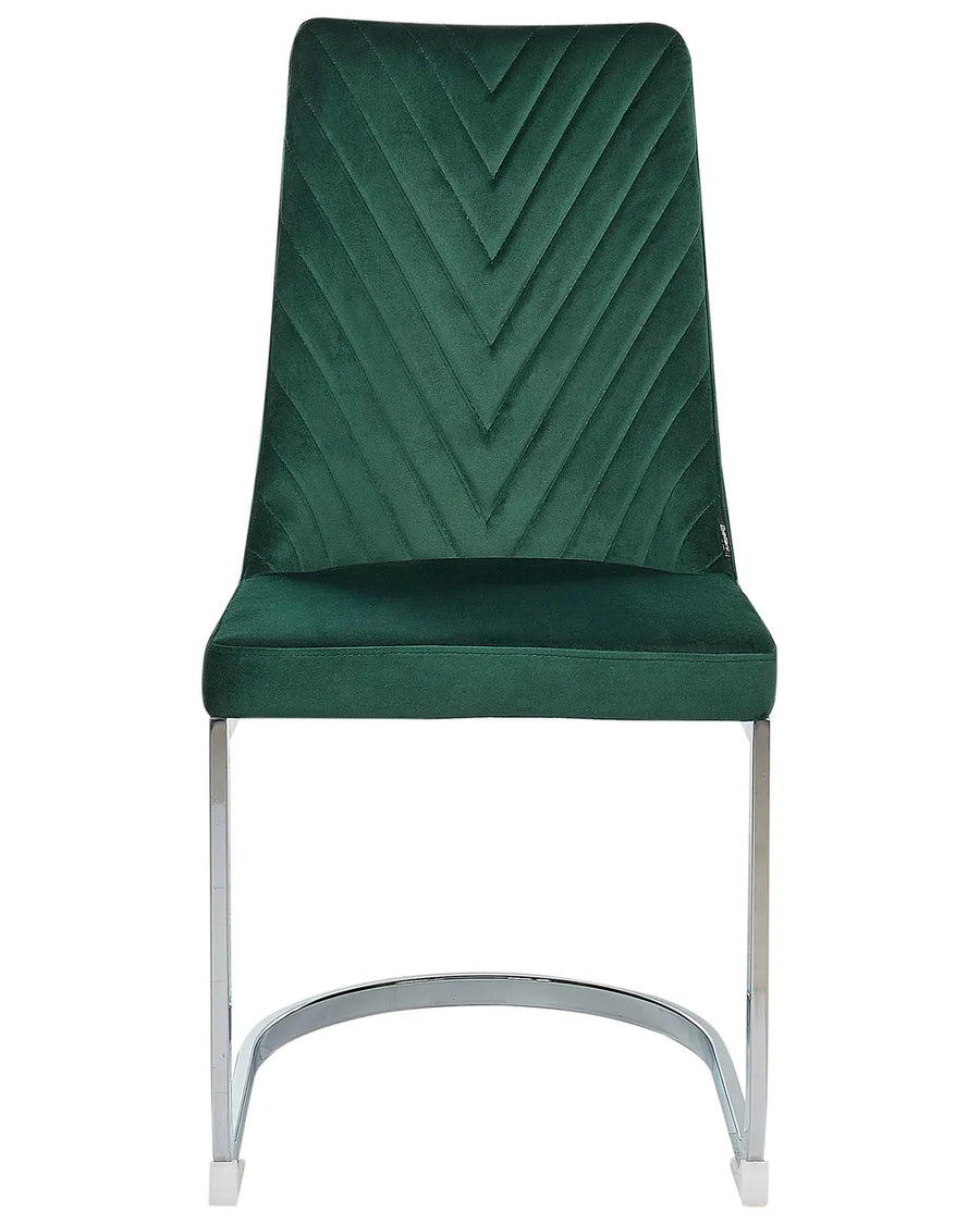Green velvet cantilever dining chair with chrome frame.
