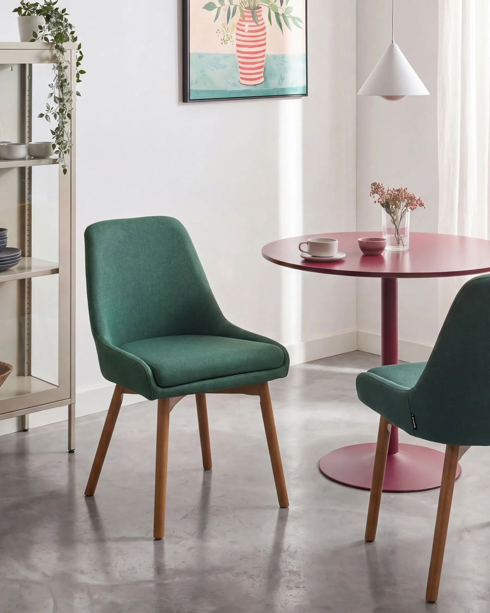 Modern green dining chairs styled around a round statement table, adding a fresh pop of colour and Scandinavian-inspired charm to a bright dining space.