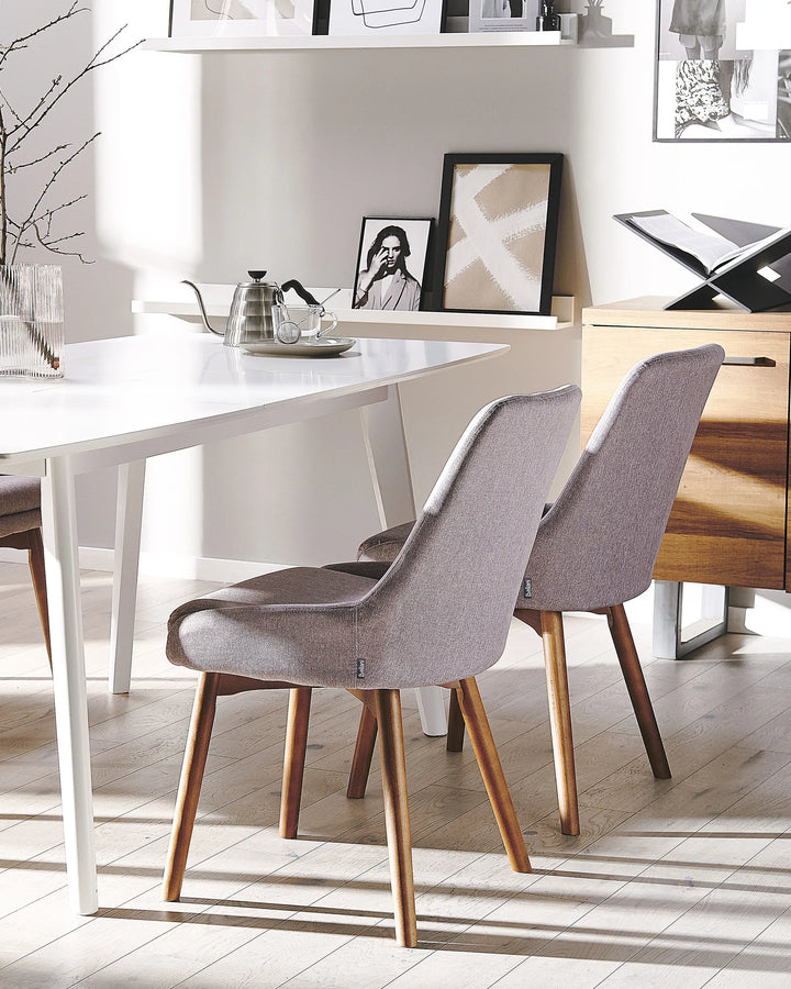 Modern upholstered dining chairs paired with a white dining table, bringing warmth and Scandinavian-inspired style to the dining area.