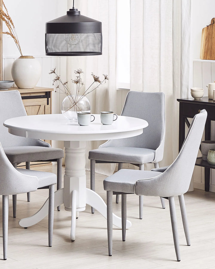 Elegant light grey dining chairs paired with a white dining table, creating a bright, sophisticated, and inviting dining space.