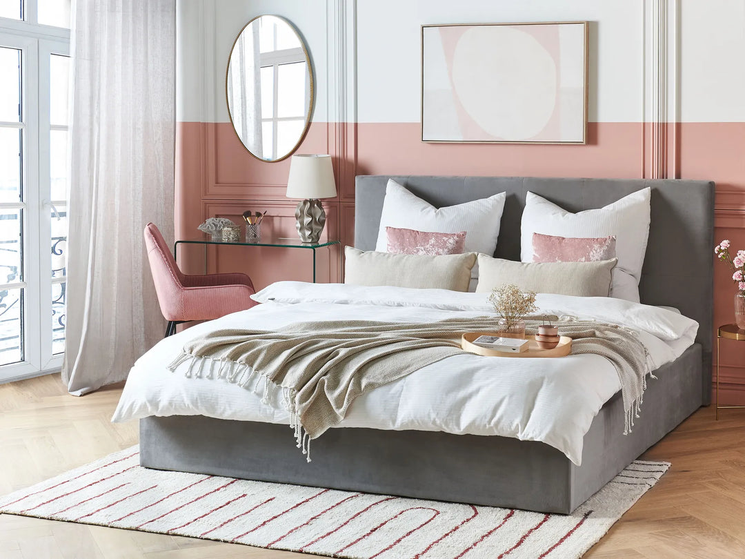 Neatly made bed with decorative pillows in a stylish bedroom.