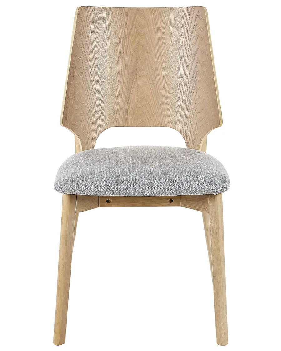 Contemporary dining chair featuring a sculptural two-tone wood backrest, light oak-effect frame, and a generously padded grey fabric seat. The distinctive geometric silhouette combines modern craftsmanship with everyday comfort, making it an elegant addition to dining rooms, kitchens, and open-plan living spaces.