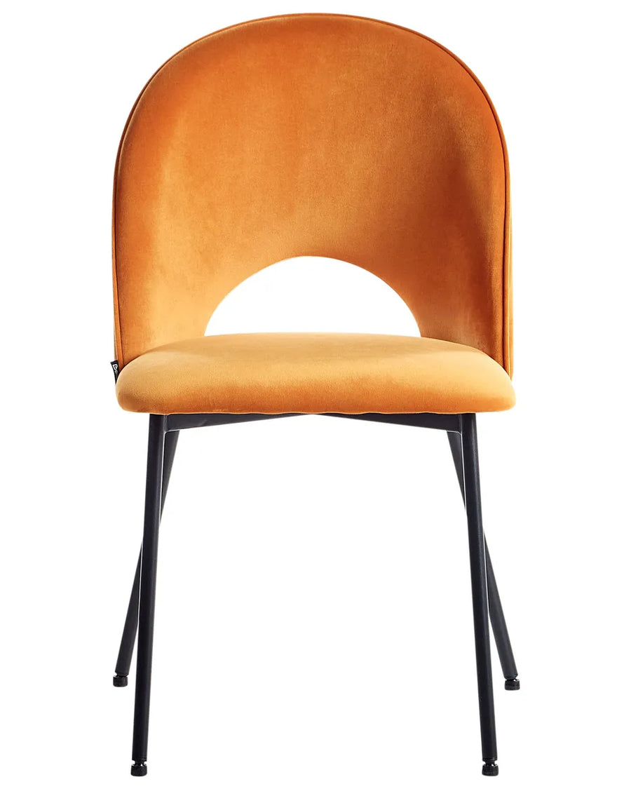 Modern dining chair with vibrant mustard velvet upholstery, a sculptural curved backrest, and slim black metal legs for a bold contemporary statement.