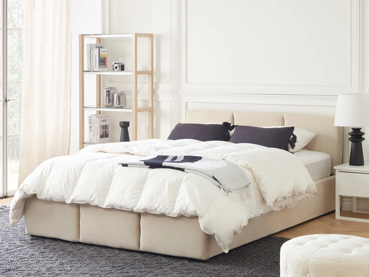 Neatly made bed with white bedding
