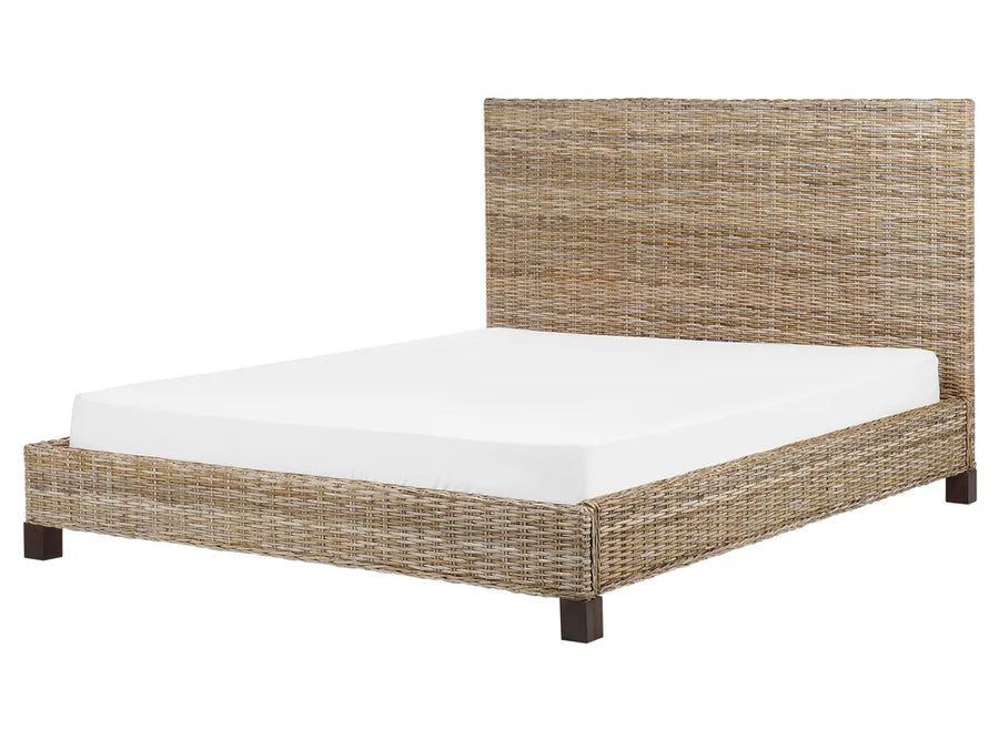 Wicker bed frame with white mattress on a white background