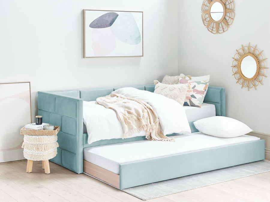 Light blue bed with white bedding in a bedroom setting