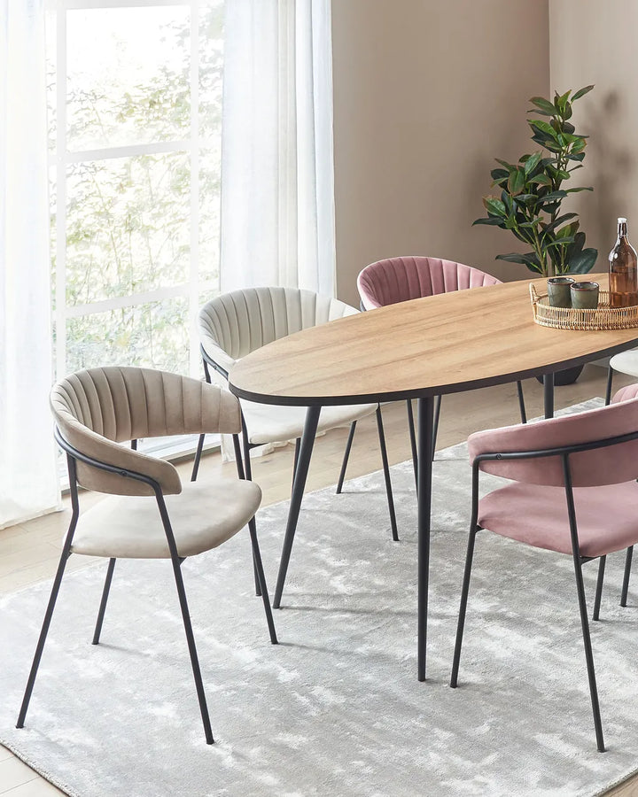 Taupe velvet dining chairs styled around a wooden dining table in a bright, modern dining room.