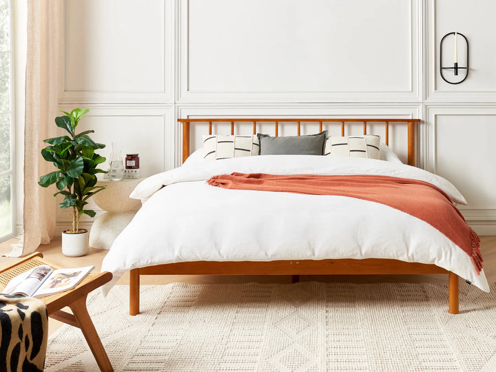 Natural ash wood bed frame with panel headboard and white mattress, clean white background, modern Scandinavian style.