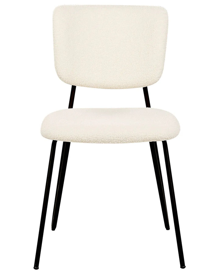 Cream bouclé dining chair with a soft upholstered seat and backrest, supported by sleek black metal legs.