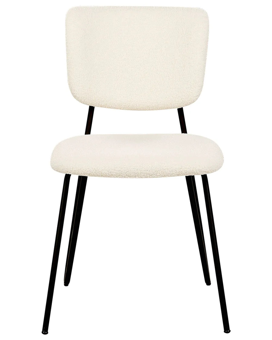 Cream bouclé dining chair with a soft upholstered seat and backrest, supported by sleek black metal legs.