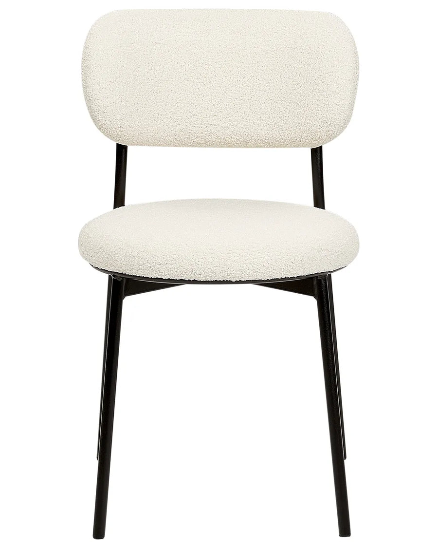 Cream bouclé dining chair with a rounded backrest, cushioned seat, and slim black metal legs for a clean modern look.