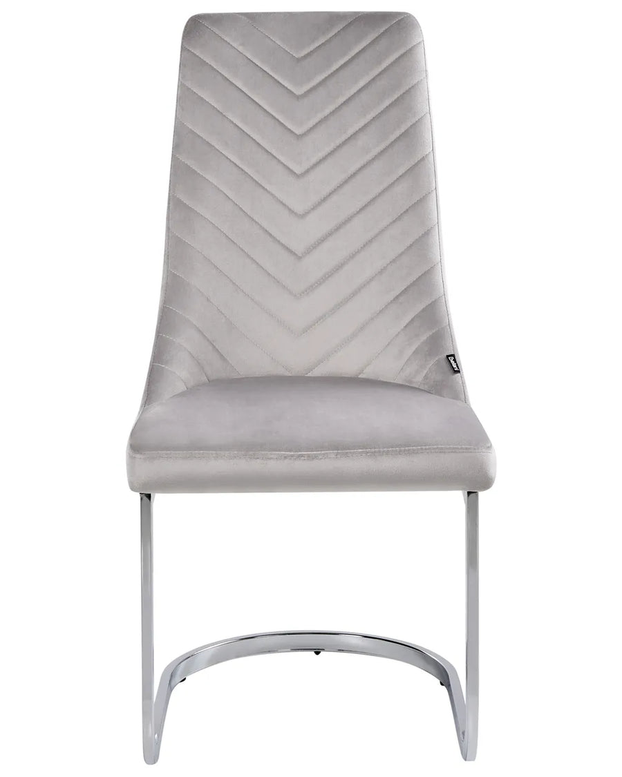 Light grey velvet cantilever dining chair with a chevron-stitched high back, padded seat, and polished chrome sled base for a sleek, modern look.