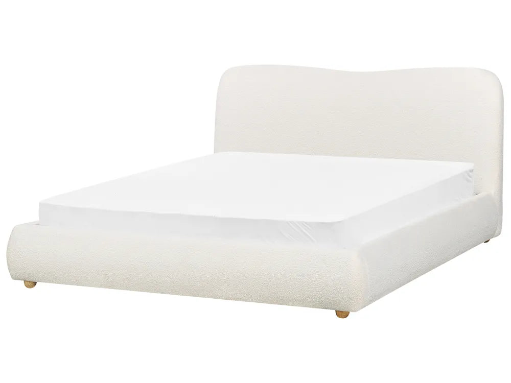 White bed with a white mattress on a white background