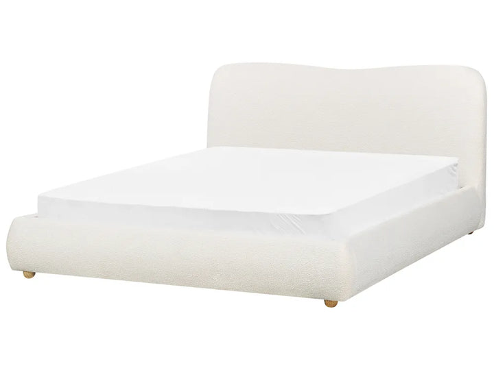 White bed with a white mattress on a white background