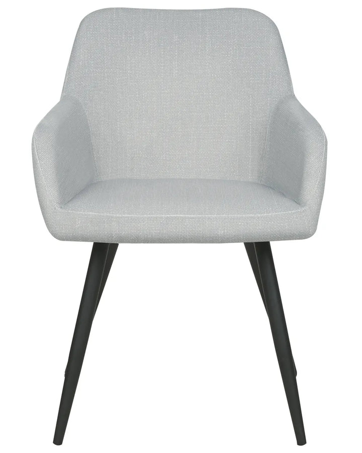 Light grey velvet dining chair with a rounded upholstered backrest, padded seat with integrated armrests, and slanted black metal legs.