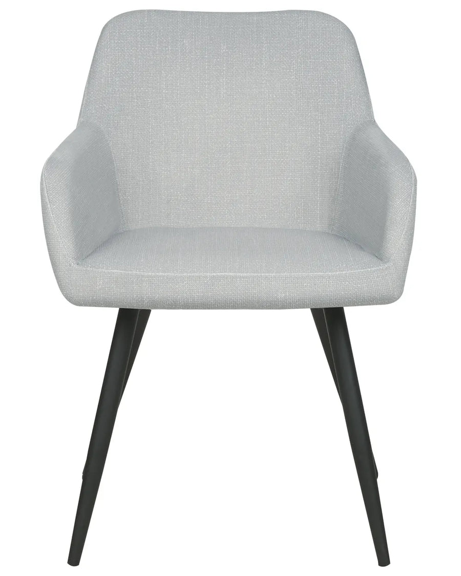 Light grey velvet dining chair with a rounded upholstered backrest, padded seat with integrated armrests, and slanted black metal legs.
