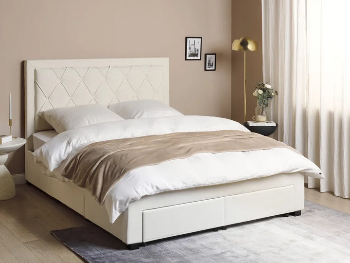 White upholstered bed with beige blanket