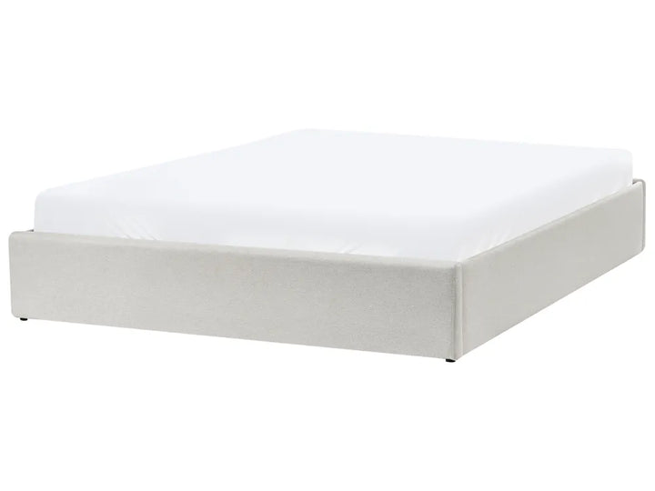 White bed frame with mattress on a white background