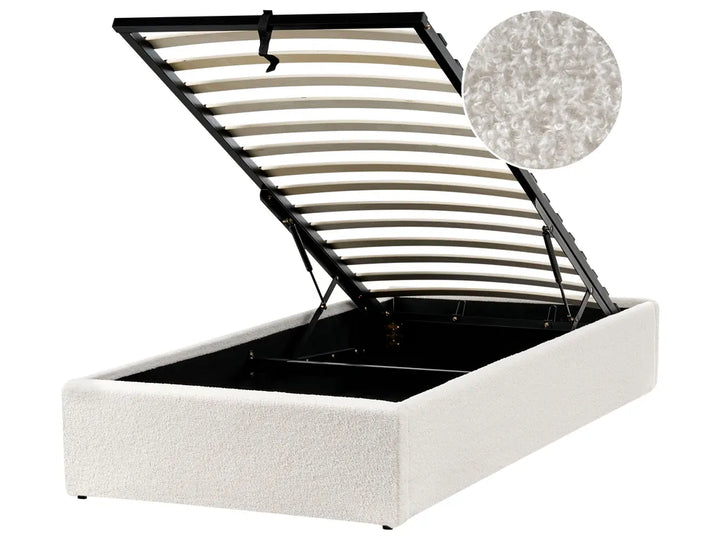 White upholstered bed frame with metal slat support on a white background