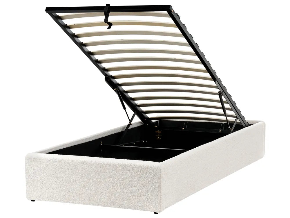 White upholstered bed frame with black metal headboard 