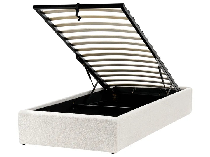 White upholstered bed frame with black metal headboard 