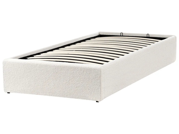 White upholstered bed frame on a white background