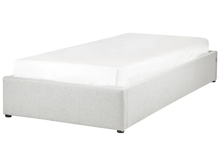 White bed frame with mattress on a white background
