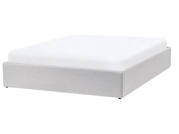 White bed frame with mattress on a white background
