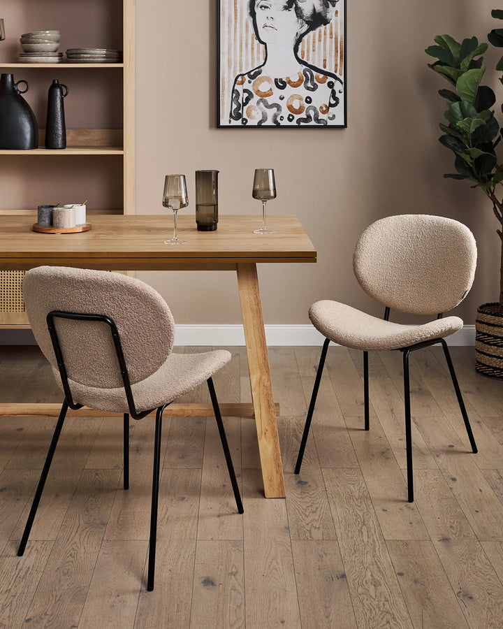 Paired with a natural wood dining table, these contemporary bouclé chairs bring warmth, texture, and Scandinavian-inspired style to any dining space.