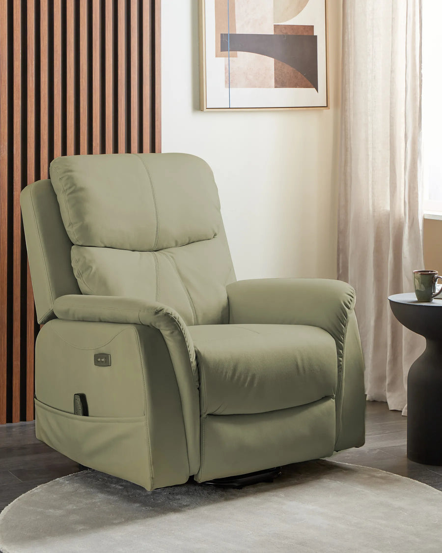 Green recliner chair in a living room setting with a abstract painting on the wall.