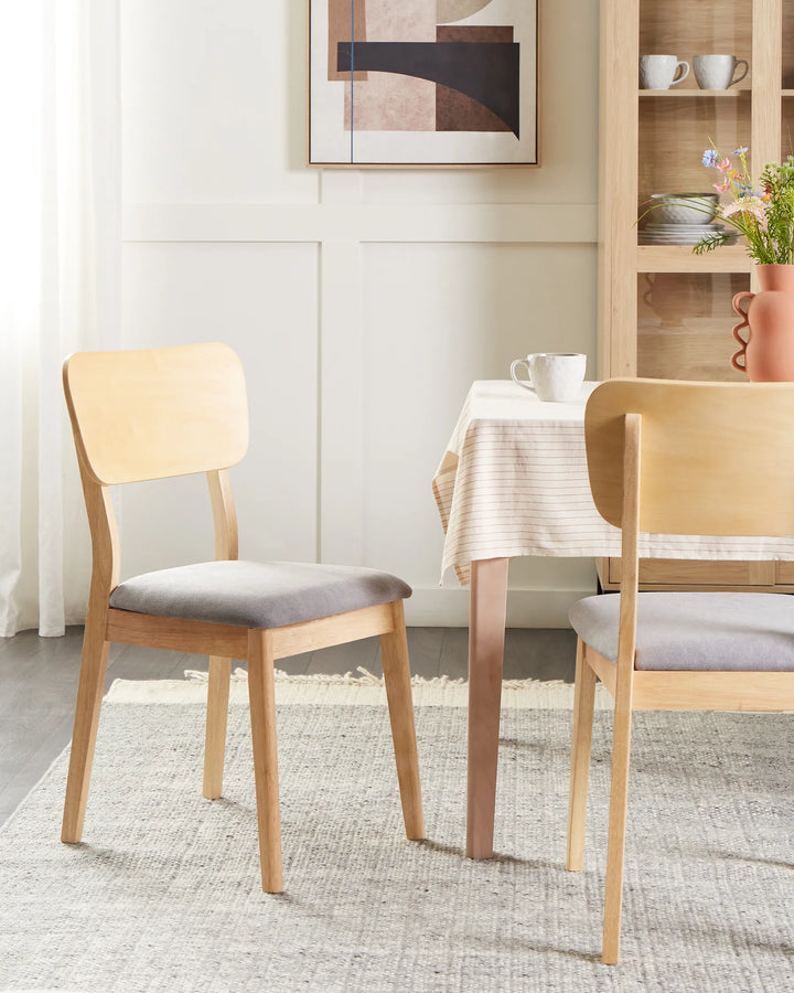 Natural wood dining chairs styled in a bright, cozy dining setting with soft neutral tones, creating a clean, modern, and welcoming atmosphere for everyday dining.