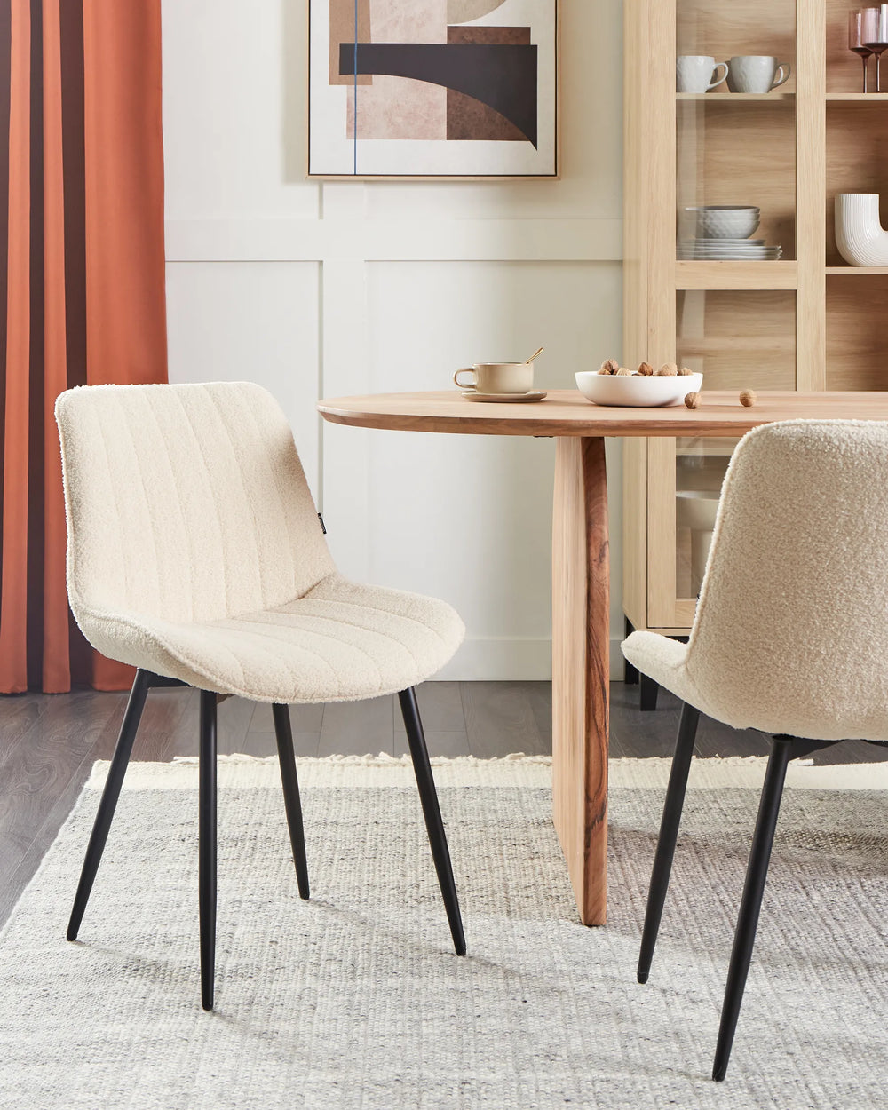 Warm contemporary dining space featuring the bouclé chairs paired with a natural wood table, creating an inviting and elegant atmosphere.