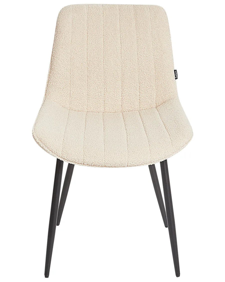 Cream bouclé dining chair with soft textured upholstery, subtle vertical stitching, and slim black metal legs for a modern, cozy look.